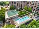 Aerial view of resort-style pool, lush landscaping, and building at 1820 Peachtree Nw St # 607, Atlanta, GA 30309