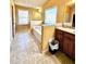 Well-lit bathroom showcasing a built-in tub, neutral tiles, and ample natural light from a window at 3026 Bridge Walk Dr, Lawrenceville, GA 30044