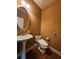 Cozy bathroom with pedestal sink and modern toilet at 3026 Bridge Walk Dr, Lawrenceville, GA 30044