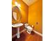 Elegant powder room with an oval mirror and hardwood floors at 3026 Bridge Walk Dr, Lawrenceville, GA 30044