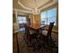 Elegant dining room with a chandelier, large windows, and a wooden table with upholstered chairs on an area rug at 3026 Bridge Walk Dr, Lawrenceville, GA 30044