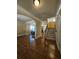 Welcoming foyer with gleaming hardwood floors, arched doorways, a staircase, and views of the dining room at 3026 Bridge Walk Dr, Lawrenceville, GA 30044