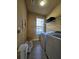 Functional laundry room with tile floors and storage shelves at 3026 Bridge Walk Dr, Lawrenceville, GA 30044