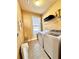 Convenient laundry room with washer, dryer, and overhead storage at 3026 Bridge Walk Dr, Lawrenceville, GA 30044