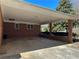 Brick carport with concrete flooring and overhead light at 5670 Lanny Dr, Powder Springs, GA 30127