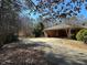 Brick home with attached carport and a long driveway at 5670 Lanny Dr, Powder Springs, GA 30127