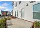 A cozy backyard patio beside white siding and windows under a bright blue sky at 1026 Cagle Creek Overlook, Canton, GA 30115