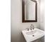 This bathroom features a white pedestal sink and a framed mirror at 1026 Cagle Creek Overlook, Canton, GA 30115