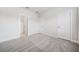 This bedroom features new, gray carpeting and white trim at 1026 Cagle Creek Overlook, Canton, GA 30115