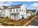 Charming two-story white home with manicured front yard landscaping and covered entryway, on a sunny corner lot at 1026 Cagle Creek Overlook, Canton, GA 30115