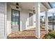 Charming front porch with brick floor, white columns, and an inviting front door at 1026 Cagle Creek Overlook, Canton, GA 30115
