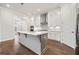 Modern kitchen featuring stainless steel appliances, white cabinets, and a kitchen island at 1026 Cagle Creek Overlook, Canton, GA 30115