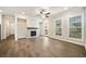 Bright living room features a stone fireplace, ceiling fan, hardwood floors, and natural light at 1026 Cagle Creek Overlook, Canton, GA 30115