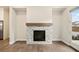 Bright living room with decorative stone fireplace, mantle, and hardwood flooring at 1026 Cagle Creek Overlook, Canton, GA 30115
