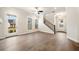 Bright living room featuring hardwood floors, staircase, and a ceiling fan at 1026 Cagle Creek Overlook, Canton, GA 30115