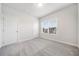 Well-lit bedroom with grey carpet and window view at 1026 Cagle Creek Overlook Trl, Canton, GA 30114