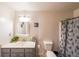 Bathroom with a vanity, mirror, toilet, and shower with a cat-themed curtain at 381 Mount Moriah Rd, Auburn, GA 30011