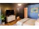 Bedroom with a TV, dresser, neutral walls, and wood floors at 381 Mount Moriah Rd, Auburn, GA 30011