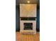 Brick fireplace with black mantle and hearth on a wood floor at 381 Mount Moriah Rd, Auburn, GA 30011