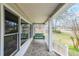 Inviting front porch featuring a charming porch swing and stone flooring at 381 Mount Moriah Rd, Auburn, GA 30011