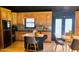 Updated kitchen with wooden cabinets, black appliances, and a mobile island with seating at 381 Mount Moriah Rd, Auburn, GA 30011