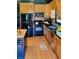 Well-lit kitchen featuring wood cabinets, black appliances, and granite countertops at 381 Mount Moriah Rd, Auburn, GA 30011