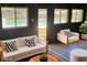 Bright living room with a view of the outdoor pool, modern furniture, and stylish decor at 381 Mount Moriah Rd, Auburn, GA 30011