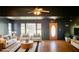 Living room with dark walls, light colored sofas and chairs, and hardwood floors at 381 Mount Moriah Rd, Auburn, GA 30011