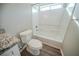 Simple bathroom with a shower/tub combo and wood-look flooring at 540 Lakecourt Dr, Mcdonough, GA 30253