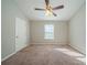 Bright bedroom with ceiling fan and neutral carpeting at 540 Lakecourt Dr, Mcdonough, GA 30253