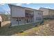 Multi-story home with a balcony and walk-out basement overlooking a modest yard at 1202 Ida Woods Ln, Lawrenceville, GA 30045