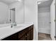 Bright bathroom features a shower-tub combo and vanity with modern fixtures at 1202 Ida Woods Ln, Lawrenceville, GA 30045