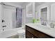 Bathroom features a shower-tub combo and vanity with modern fixtures at 1202 Ida Woods Ln, Lawrenceville, GA 30045