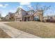 Two story home featuring brick and siding, an attached two car garage, and a covered front porch at 1202 Ida Woods Ln, Lawrenceville, GA 30045