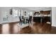 Open concept kitchen with stainless steel appliances, dark wood cabinetry, granite countertops, and hardwood floors at 1202 Ida Woods Ln, Lawrenceville, GA 30045