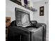 A large gray front-load washer and dryer are in the home's laundry room at 1202 Ida Woods Ln, Lawrenceville, GA 30045