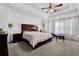 Spacious main bedroom features a ceiling fan, neutral carpet, and an ensuite bathroom at 1202 Ida Woods Ln, Lawrenceville, GA 30045