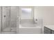 Bathroom with shower and garden tub at 13550 Whitman Se Ln, Covington, GA 30014