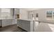 Open concept kitchen with gray cabinets, island, and breakfast area at 13550 Whitman Se Ln, Covington, GA 30014