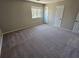 Bedroom with neutral carpeting and window at 1037 Forest Path, Stone Mountain, GA 30088