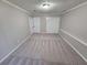 Spacious bedroom with neutral carpeting and double doors at 1037 Forest Path, Stone Mountain, GA 30088