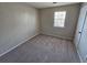 Bright bedroom featuring neutral walls and carpeted floors at 1037 Forest Path, Stone Mountain, GA 30088