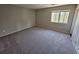 Bedroom with neutral carpeting and a window at 1037 Forest Path, Stone Mountain, GA 30088