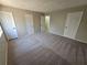 Bedroom with neutral carpeting and doors at 1037 Forest Path, Stone Mountain, GA 30088