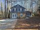 Gray house with stone accents and a spacious yard at 1037 Forest Path, Stone Mountain, GA 30088