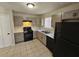 Kitchen with gray cabinets, gas range and black appliances at 1037 Forest Path, Stone Mountain, GA 30088