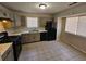 Kitchen with gray cabinets, gas range and black appliances at 1037 Forest Path, Stone Mountain, GA 30088