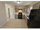 Kitchen with gray cabinets, gas range and black appliances at 1037 Forest Path, Stone Mountain, GA 30088