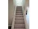 Carpeted stairway with simple railings leading to the upper level at 1037 Forest Path, Stone Mountain, GA 30088