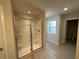 Bright bathroom featuring a glass enclosed shower, neutral paint and tile floors at 262 Depot Landing Rd # 51, Auburn, GA 30011